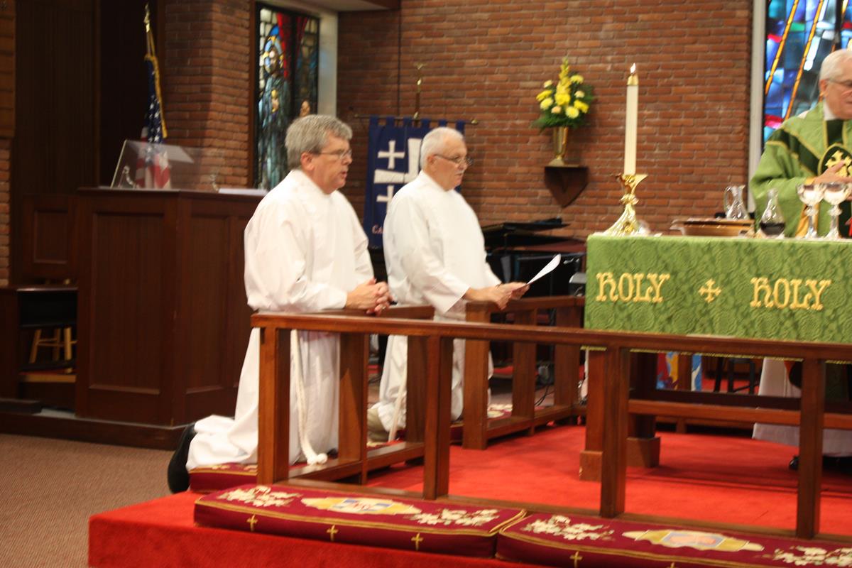 Eucharistic Ministers kneeling during service at Calvary Episcopal Church 